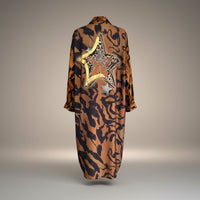 GRINE long flowing shirt dress with animal print, gold star detail and sequin embellishments. 100% Viscose.