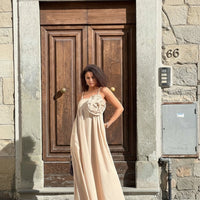 GRINE light beige cotton maxi dress with spaghetti straps and a removable flower detail on the bust. Model is wearing a size S.