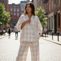 GRINE beige linen checkered wide-leg pants with drawstring waist and scalloped pockets. Relaxed fit, ideal for warm weather.