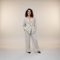 GRINE beige linen blend oversized blazer with black pinstripes, paired with matching wide-leg trousers.