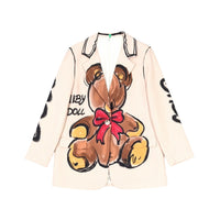 GRINE beige oversized blazer with a central teddy bear print and red bow detail. Features wide lapels and a casual-chic style.