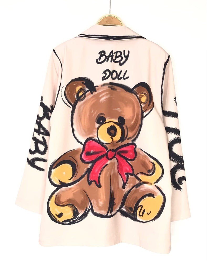 Blazer oversized bege GRINE com estampa de urso castanho e laço vermelho nas costas e texto Baby Doll