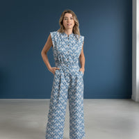 GRINE blue ikat print wide-leg jumpsuit with button front, elastic waist, and side pockets.