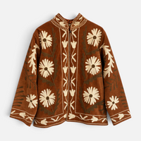 Casaco Grine de veludo camel com bordados florais estilo Suzani, gola subida e acabamentos detalhados.