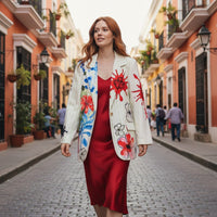 GRINE long white/cream blazer with a vibrant floral print and green pinstripes. Features red paint splatters and abstract black details.