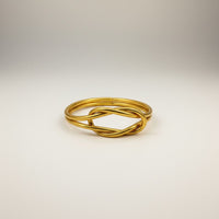 GRINE gold-tone infinity knot bracelet, handmade, flexible, waterproof, symbolizing union, luck, and love.