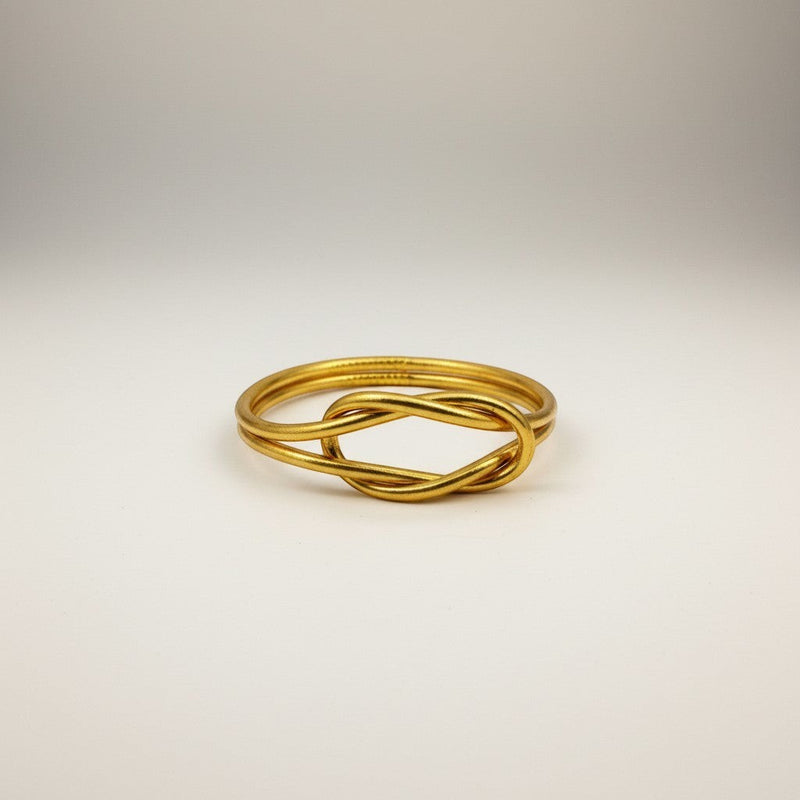 GRINE gold-tone infinity knot bracelet, handmade, flexible, waterproof, symbolizing union, luck, and love.