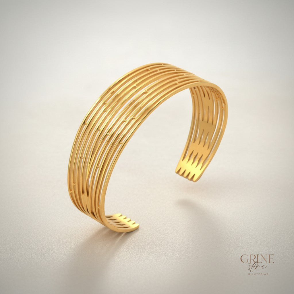 GRINE gold-tone stainless steel cuff bracelet with openwork design and polished finish. Adjustable size.