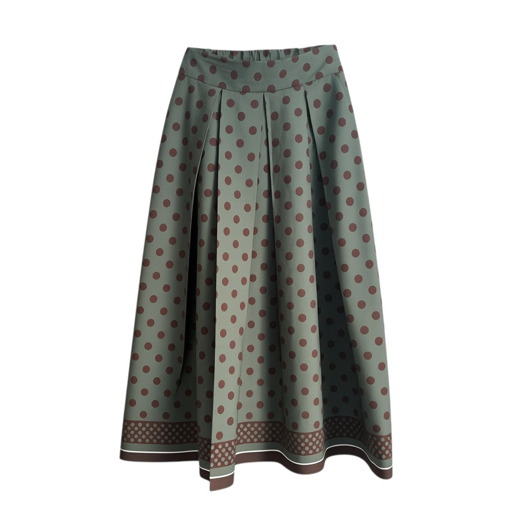 GRINE green midi skirt with brown polka dots and elastic waist. Features a fluid cut and a decorative border at the hem.