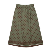 GRINE green midi skirt with brown polka dots and a decorative border at the hem. Elasticated waist for comfort.