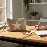 GRINE light grey textile pouch with a large white star graphic and removable wrist strap, perfect for beach essentials.