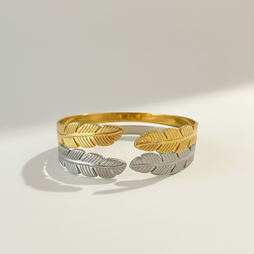 GRINE gold and silver stainless steel cuff bracelet with leaf design. Adjustable and hypoallergenic.