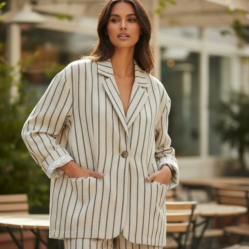 GRINE sand-colored oversized linen-blend blazer with black pinstripes and a single button closure.