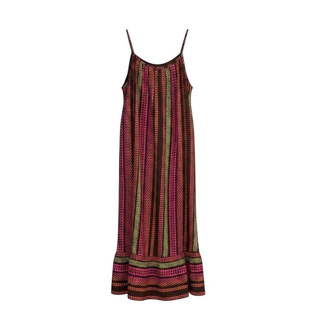 GRINE Anita long flowing cotton dress with ethnic multicolor pattern, pink, orange, brown, and green. Features thin straps and a ruffled hem.