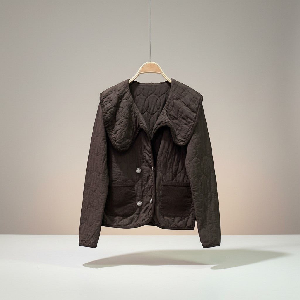 GRINE Marie short brown quilted jacket with a large collar, two faux pockets, and a decorative clasp closure.