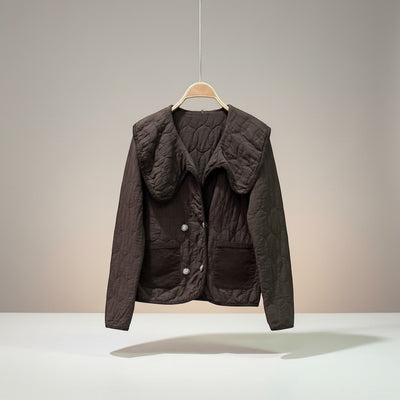 GRINE Marie short brown quilted jacket with a large collar, two faux pockets, and a decorative clasp closure.