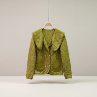 GRINE short quilted jacket in olive green with a large collar, two faux pockets, and decorative buttons.