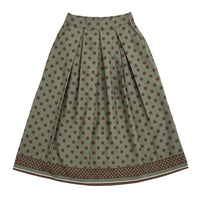 GRINE Marie midi skirt in olive green with brown polka dots and a tiered hem. Features a flattering A-line cut and elasticated waistband.