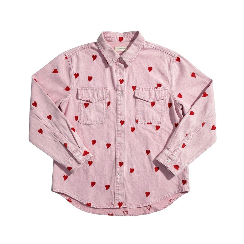 GRINE pink denim shirt jacket with red embroidered hearts, featuring two chest pockets and a button-up front.