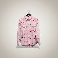 GRINE pink denim shirt jacket with red embroidered hearts, featuring two chest pockets and a button-down front.