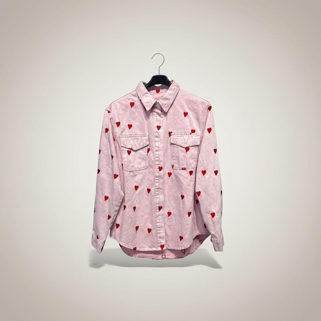 GRINE pink denim shirt jacket with red embroidered hearts, featuring two chest pockets and a button-down front.