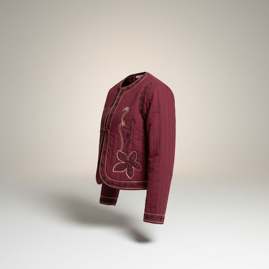 GRINE plum quilted jacket with floral embroidery and tie front closure. Short, lined, and sleeveless.