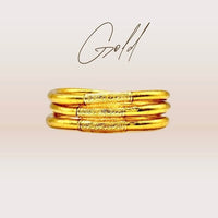 Pulseira GRINE artesanal budista dourada com folha de ouro e conector de cobre gravado com mantra de sorte e amor.