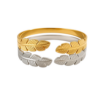 Pulseira GRINE Leaves em aço inoxidável com design de folhas, disponível em tons dourado e prateado, ajustável.