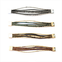 Quatro pulseiras GRINE Phuket com cordões de pele, contas metálicas e fecho magnético em várias cores.