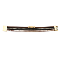 Pulseira GRINE Siberian em couro sintético castanho e preto com detalhes em liga de zinco dourada e fecho magnético.
