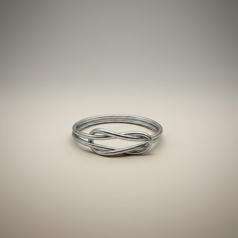 GRINE silver infinity knot bracelet, flexible, waterproof, made with gold leaf and plastic.