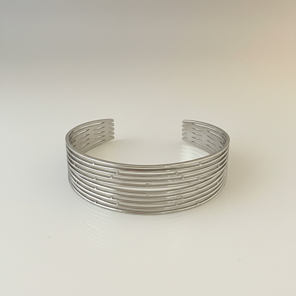 GRINE silver stainless steel cuff bracelet with a layered, open design. Adjustable and water-resistant.