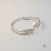 GRINE silver stainless steel cuff bracelet with delicate leaf design, adjustable and hypoallergenic.