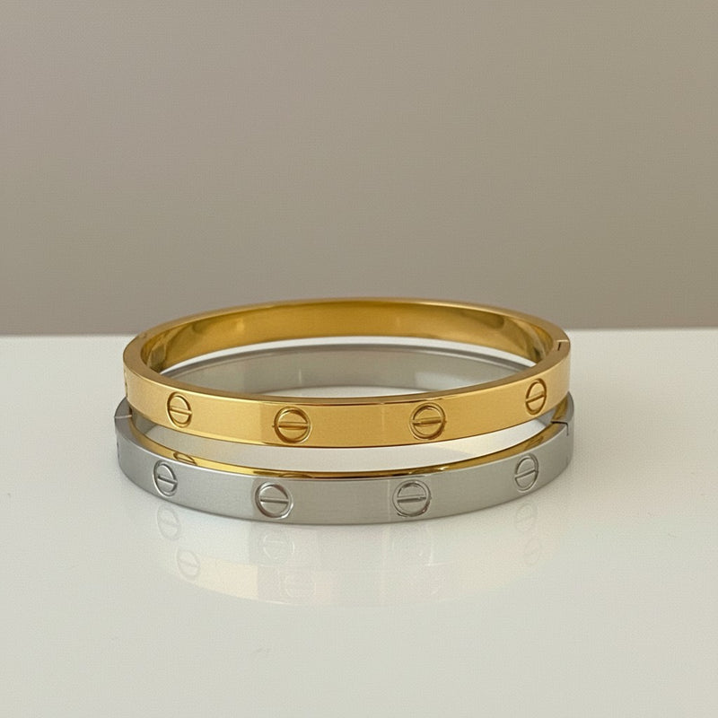 GRINE gold and silver stainless steel screw detail bangle bracelets. Modern industrial style.