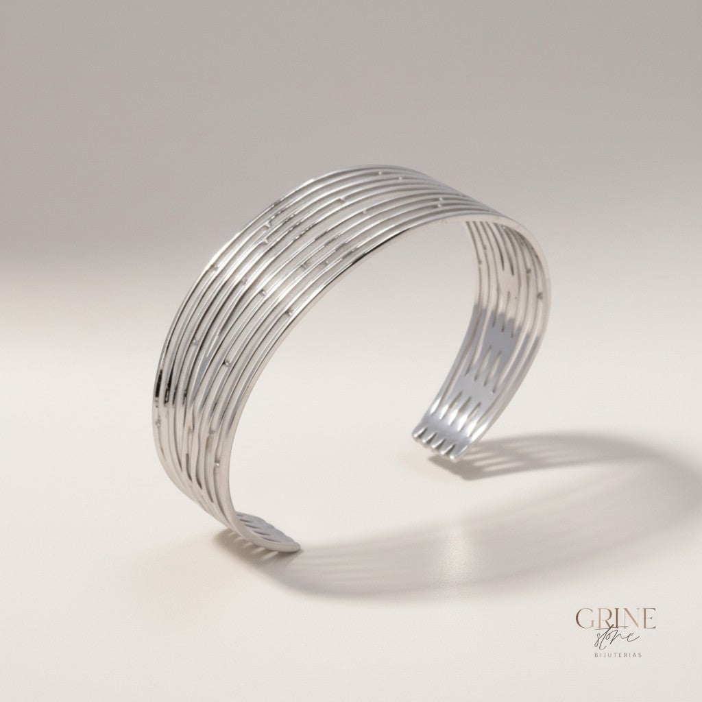 GRINE store silver-tone stainless steel cuff bracelet with multiple parallel bands and cut-out details.