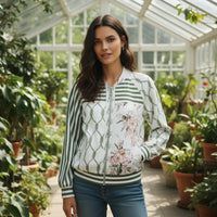GRINE bomber jacket with floral print, rope pattern, and green stripes. Velvety finish.