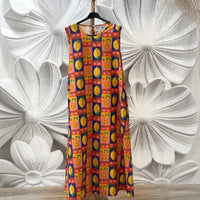 Vestido GRINE de algodão fluido com padrão multicolorido de limões, laranjas e flores, corte largo e bolsos.
