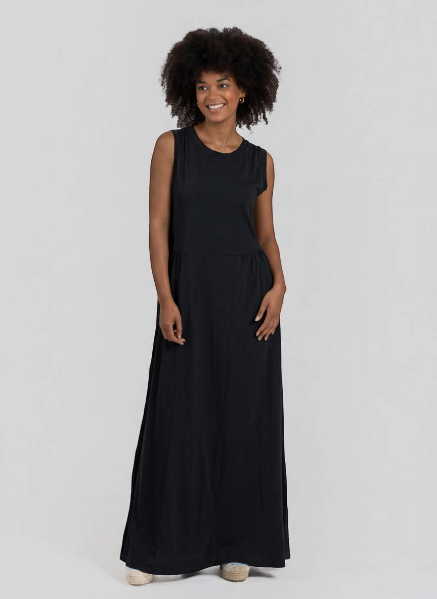 Modelo sorridente veste vestido comprido preto GRINE em algodão com corte evasê, decote redondo e sem mangas