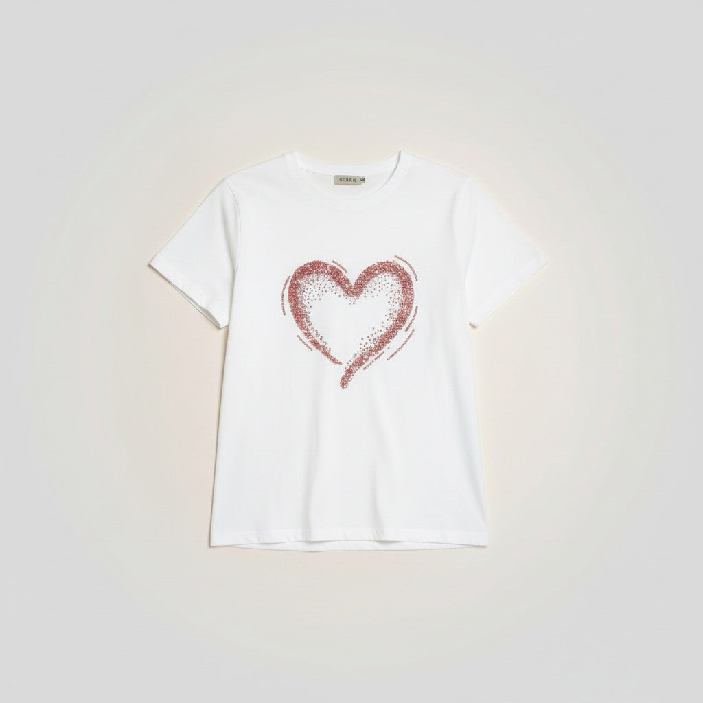 GRINE white cotton t-shirt with short sleeves, round neck, and a sequined rose gold heart graphic. Relaxed fit with a slightly wider back and gathered detail.