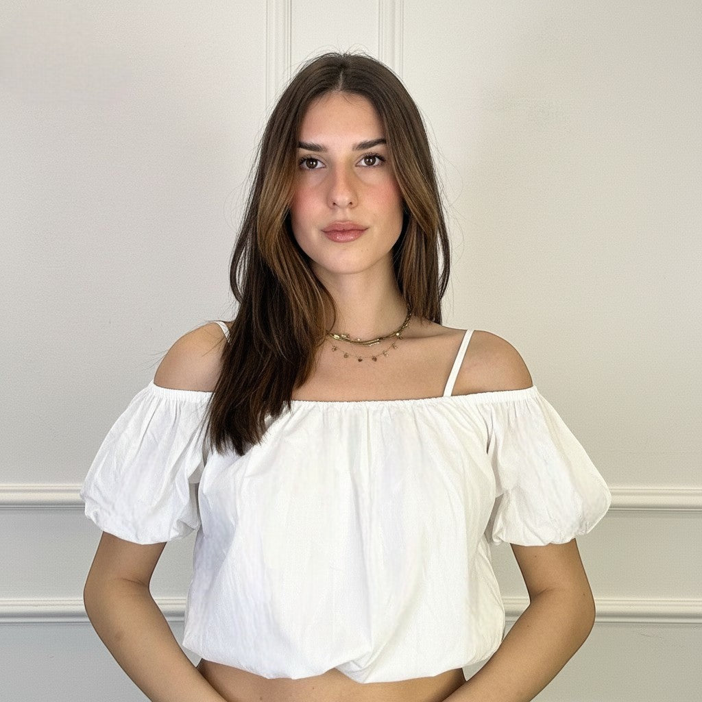 GRINE white cotton off-the-shoulder crop top with puff sleeves and a gathered neckline, worn by a model.