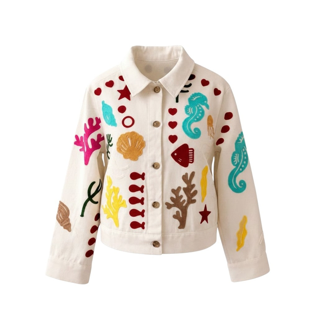 GRINE white denim jacket with colourful embroidered marine life motifs like seahorses, shells, and coral. 100% cotton.