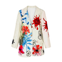 GRINE white/cream long blazer with a vibrant floral print and green pinstripes. Features red paint splatters and abstract flower designs.