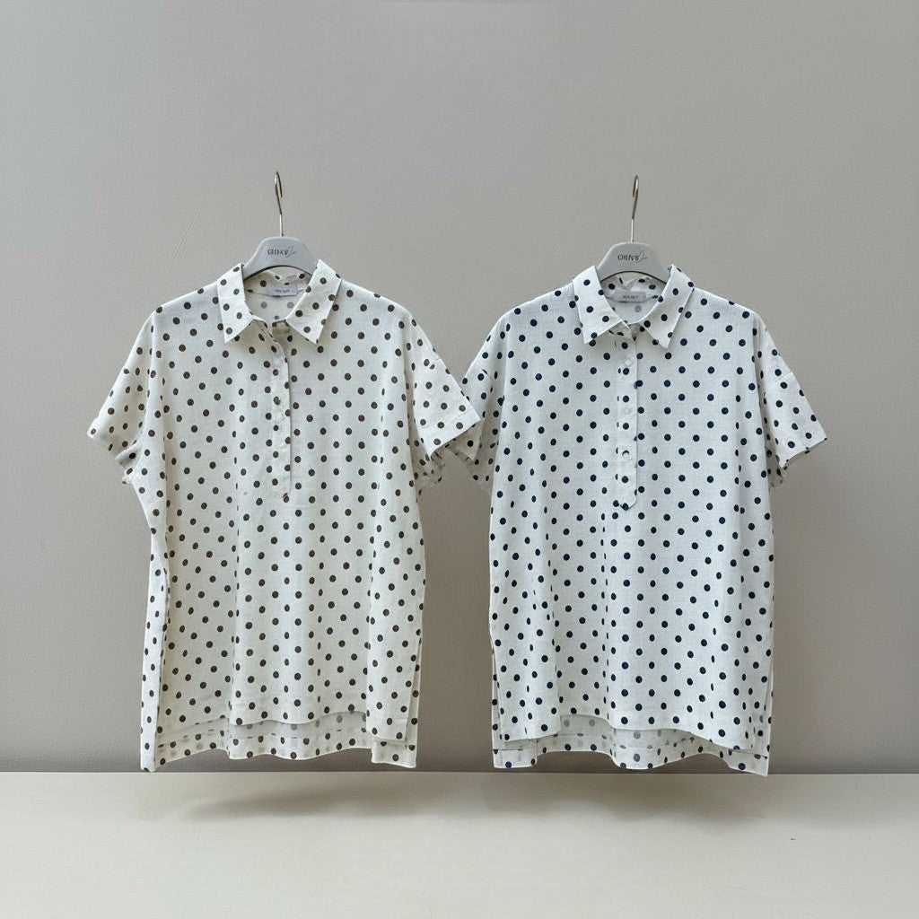 GRINE white pearl cotton shirt with dark brown polka dots, short sleeves, button-up front, side slits, and longer back.