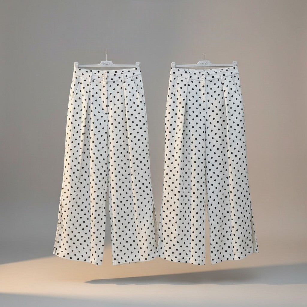 GRINE white pearl cotton trousers with black polka dot print, side slits, and button closure.