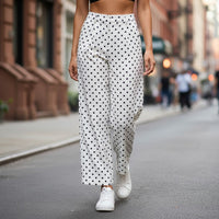 GRINE white pearl cotton trousers with black polka dot print, side slits, and button closure.