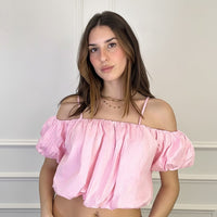 Pink Black off-the-shoulder cotton crop top with puff sleeves and spaghetti straps. Model is wearing a size S.